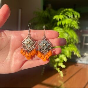 Orange and silver tone metal dangly earrings